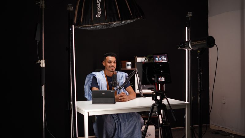 A creator recording a video in a home studio